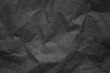 Black creased paper background texture