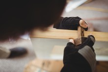 Carpenter Using Marking Gauge On A Wooden Door