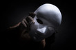 © Joe Therasakdhi - Mysterious person showing white mask in the dark,Scary background for book cover