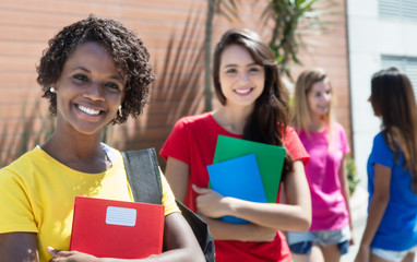 Vier junge weibliche Studentinnen in bunten Shirts