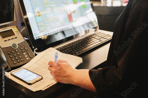 A Person Working At Hair Salon Reception Laptop Computer A Person Working At Hair Salon Reception Laptop Computer Landline Phone Diary