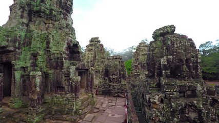 Canvas Print - Moss and lichen cling to the exterior surfaces of the ancient Bayon temple ruin near Siem Reap, Cambodia. 4k UltraHD video