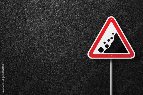 Fotografie, Obraz Road sign triangular shape with a picture of the rockfall on a background of asphalt
