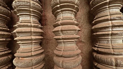 Sticker - Ancient, round, hand carved columns stand in a wall niche in the main temple complex of Angkor Wat, in Cambodia. FullHD 1080p video