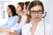 © rogerphoto - Call center operator.Young beautiful business woman in headset.