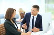 © ASDF - Image of two young businessmen using computer at meeting