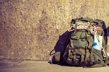 Hiking Backpack Camping Equipment Outdoor On Grunge Wall