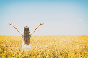 Poster - Young woman enjoying nature and sunlight in wheat field