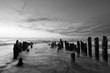 © Igor Sklyarov - Black and white photography of the sky and sea at sunset with old wooden breakwater pales at Curonian spit, Russia, Kaliningrad