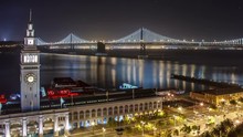 Time Lapse Of Traffic Driving Across The Bay Bridge In San Francisco. The Buildings Of San Francisco Can Be Seen In The Distance. Time Lapse.