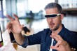 © WavebreakmediaMicro - Man wearing virtual glass in office