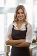 © WavebreakmediaMicro - Portrait of smiling waitress standing with arms crossed
