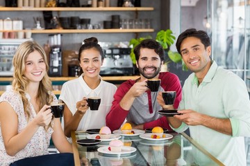 Wall Mural - Group of friends having cup of coffee together