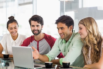 Poster - Group of friends using laptop while having cup of coffee