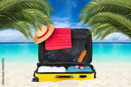 open suitcase on tropical p...