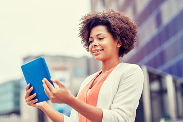 Wall Mural - happy african businesswoman with tablet pc in city