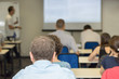 © elen31 - people sitting rear and the teacher near the desk at the business conference