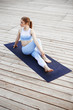 © Cookie Studio - Young beautiful blonde girl practicing yoga outside.