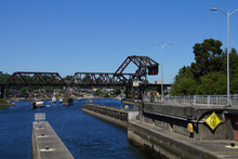 Boats Wait Under Railroad Bridge
