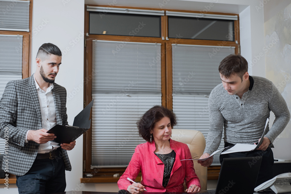 Businesswoman and his assistants secretaries in his office. The ...
