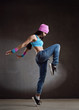 Young sexy woman dancer dancing on wall background
