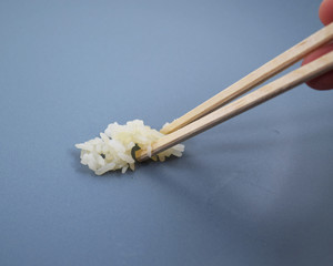 Chopsticks holding rice