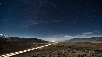Wall Mural - time lapse of a road going the desert with the night sky moving above.