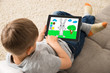 Cute Little Child Playing Game On Digital Tablet