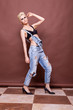 © DC Studio - Standing woman in bra and jeans in studio posing in fashion styl