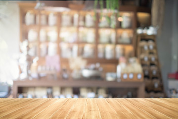 Wall Mural - Empty wood table and blurred coffee shop background. product display