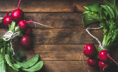 Wall Mural - Fresh radish bunches over rustic wooden background, top view, copy space, horizontal composition