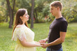 © ulza - the young beautiful pregnant woman with the husband in park in summer day