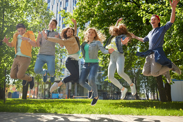 Poster - happy teenage students or friends jumping outdoors