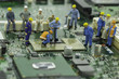engineers are fixing chip-set on green mainboard