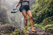 Leinwandbild Motiv Woman hiking barefoot on forest trail