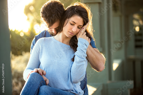 Fotografie, Obraz Beautiful lifestyle sensual sincere embrace hug sitting together at the park