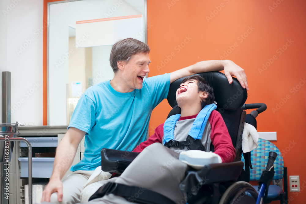 Disabled little boy in wheelchair talking with father in hospita - obrazy, fototapety, plakaty 