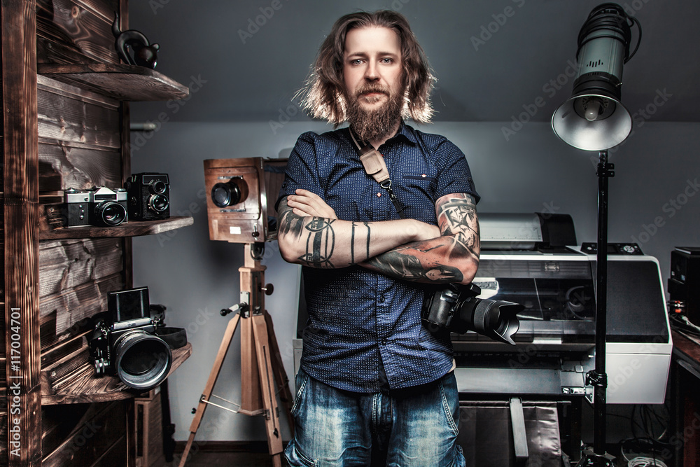 Beautiful portrait of the photographer at the workplace. The concept of the creative process, skill and favorite pastime - obrazy, fototapety, plakaty 