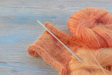 Knitting Orange Mohair Wool And Needles