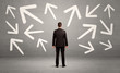 © ra2 studio - Confused salesman with arrows on wall