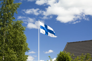 Wall Mural - Flag of Finland on blue sky background.