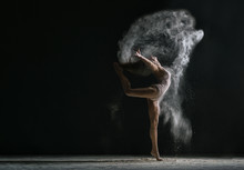 Concept. Flexible Girl Dancing In Cloud Of Dust