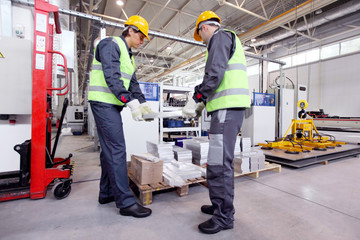 Wall Mural - Workers taking aluminium billet