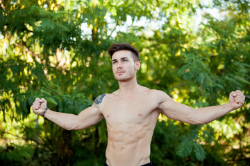 Wall Mural - Young boy with showing his muscles.