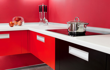 Wall Mural - Luxurious new red kitchen with modern appliances