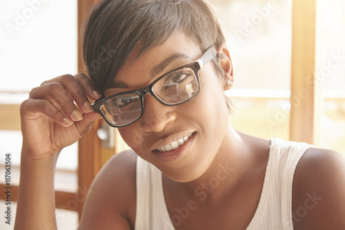 Close Up Portrait Of Dark Skinned Woman In Glasses With