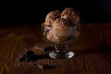 Aufkleber - Chocolate ice cream on a dark wooden background with pieces of chocolate in a glass.