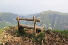 Lonely Wooden Bench On The Edge Of A High Precipice Overlooking The Deep Abyss