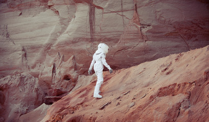 Wall Mural - futuristic astronaut on another planet, image with the effect of toning
