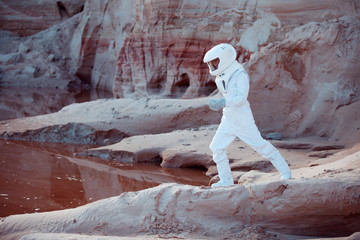 Wall Mural - Water on Mars, futuristic astronaut, image with the effect of toning